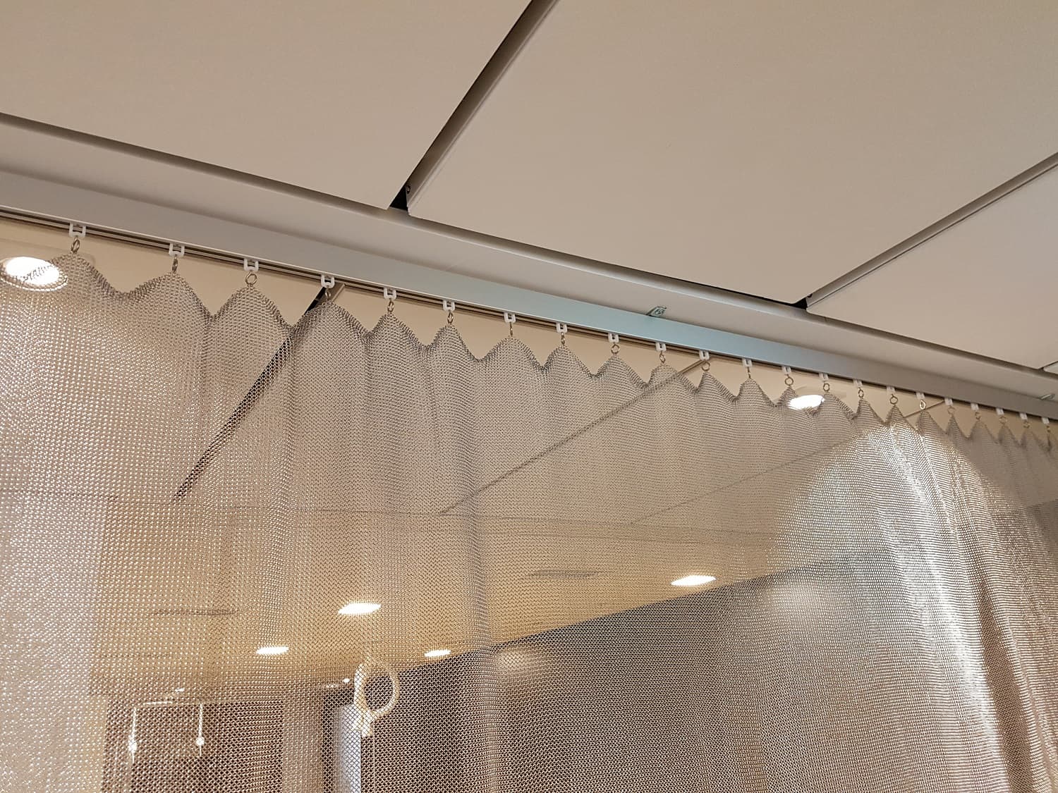 Rail directly against the ceiling for lighter metal draperies